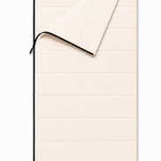 Adult organic cotton sleeping bag in undyed natural cotton, partly unzipped with the top corner folded back