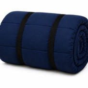 Navy blue organic cotton sleeping bag rolled up and secured with two black straps