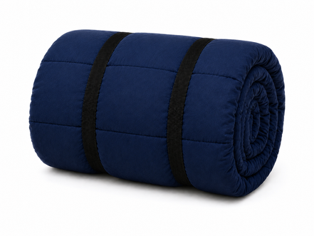 Navy blue organic cotton sleeping bag rolled up and secured with two black straps