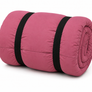 Pink junior organic cotton sleeping bag rolled up with two black straps