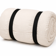 Undyed junior organic cotton sleeping bag rolled up with two black straps
